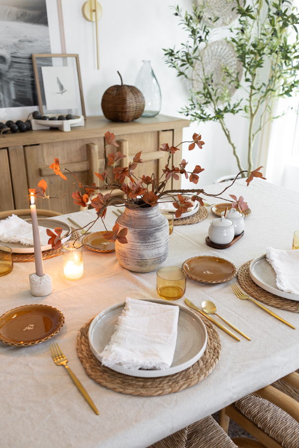 Cream linen table runner layered on a wood table as the base for a simple fall tablescape