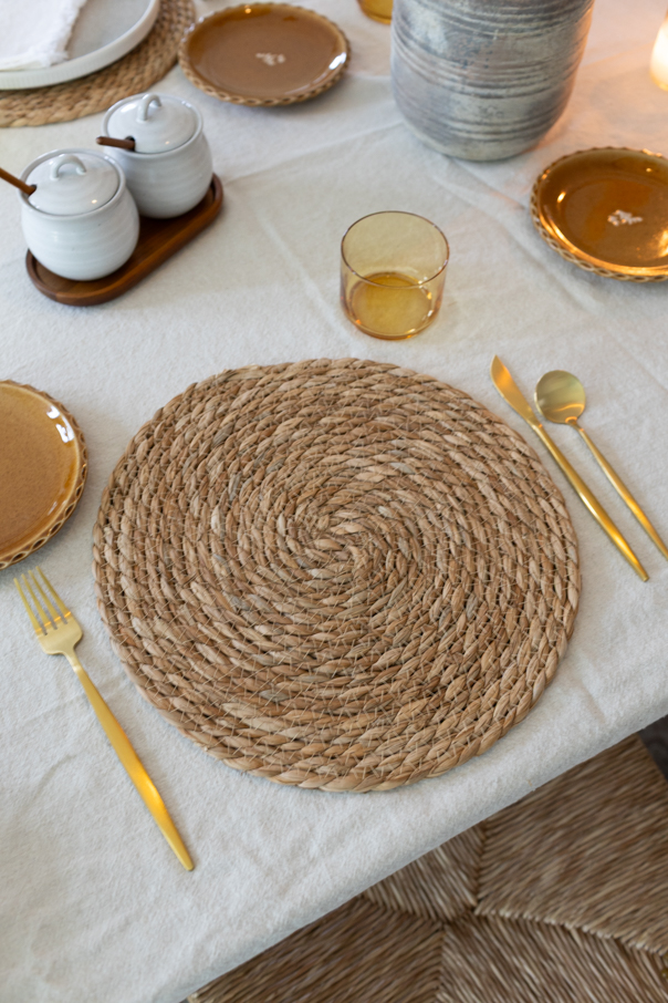 Neutral place setting with linen napkin and stoneware on an earthy fall tablescape