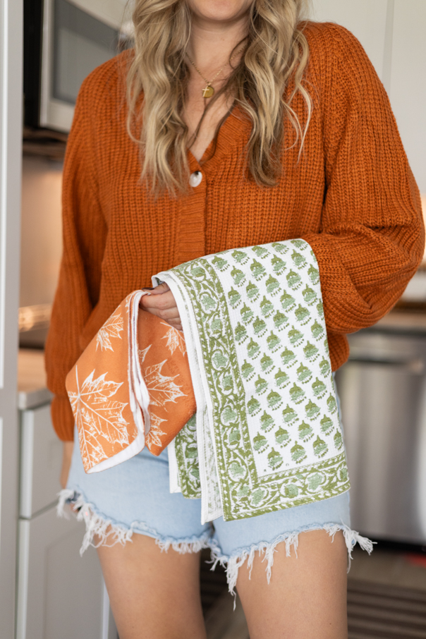Andi holding a Fall kitchen towel