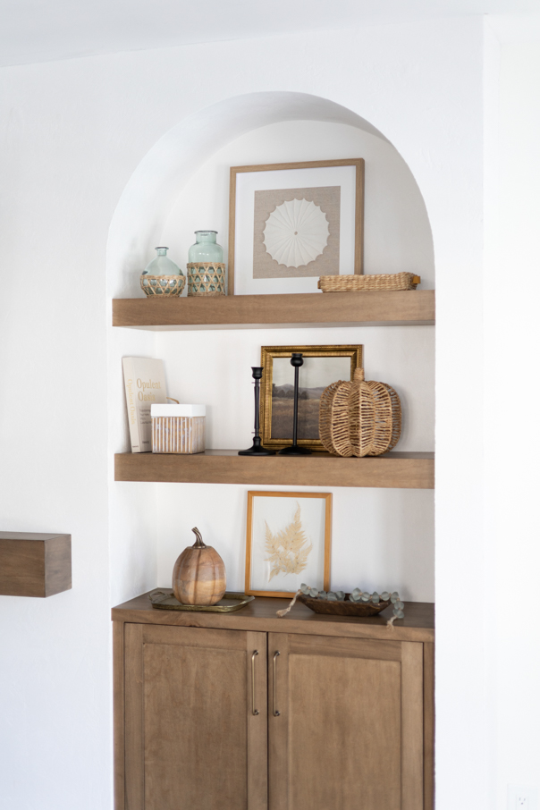 living room shelf with pumpkin decor for fall