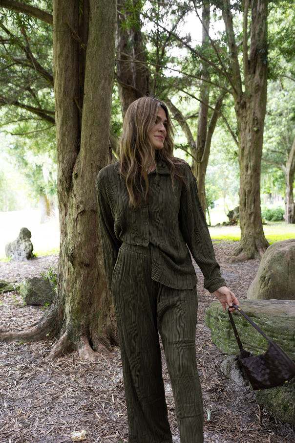 Hunter green sweater and pant set laid flat with autumn accessories