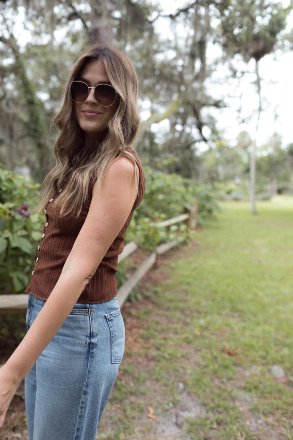 Andi smiling at camera wearing fall outfit